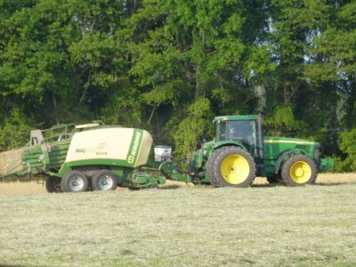 John Deere tractor pulling a Krone large square baler